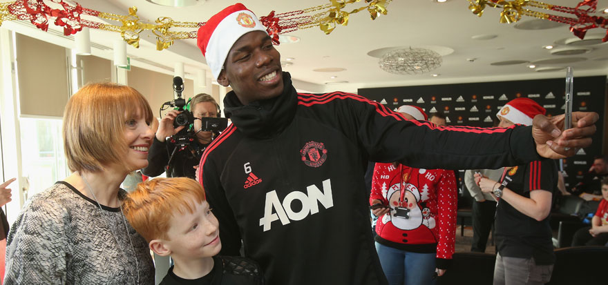 Manchester United's Paul Pogba with a young fan
