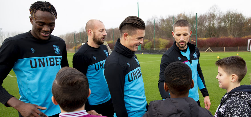 Aston Villa players meet young children
