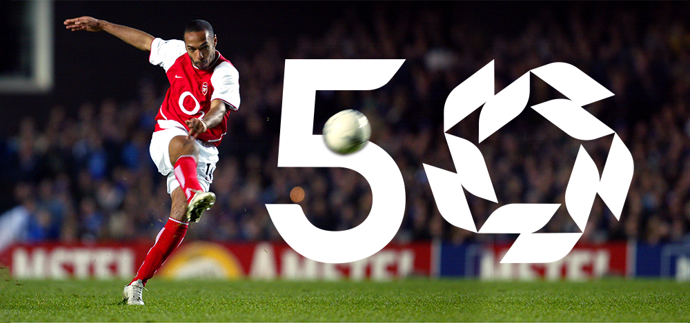 Thierry Henry kicks the ball towards the PFA Awards logo celebrating 50 years of the Awards. 