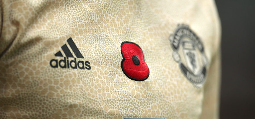 A Manchester United player wears the poppy on their kit